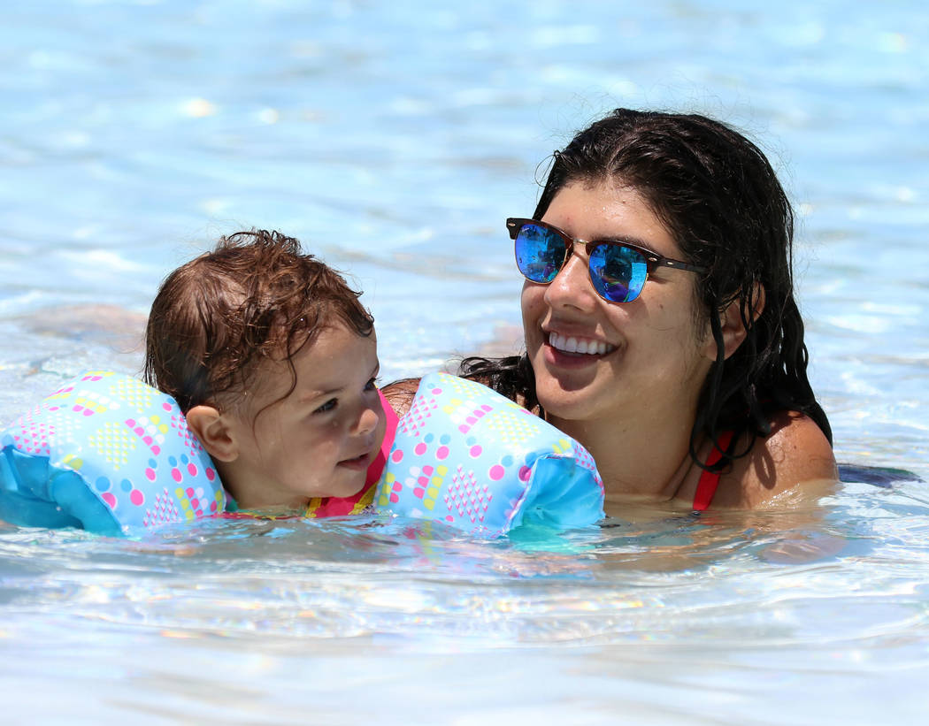Beatriz Park of Henderson swims with her daughter Emilia, 2, at the Surf-A-Rama Wave Pool at Co ...