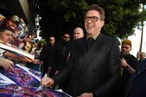 In an April 22, 2019, file photo Robert Downey Jr. signs autographs as he arrives at the premie ...