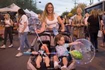 Danielle Kovacs, top/middle, pushes sons Christoper, left, 1, and Johnny, 2, during First Frida ...
