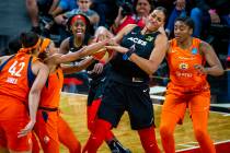 Las Vegas Aces center Liz Cambage (8) fights for the ball with Connecticut Sun guard Jasmine Th ...
