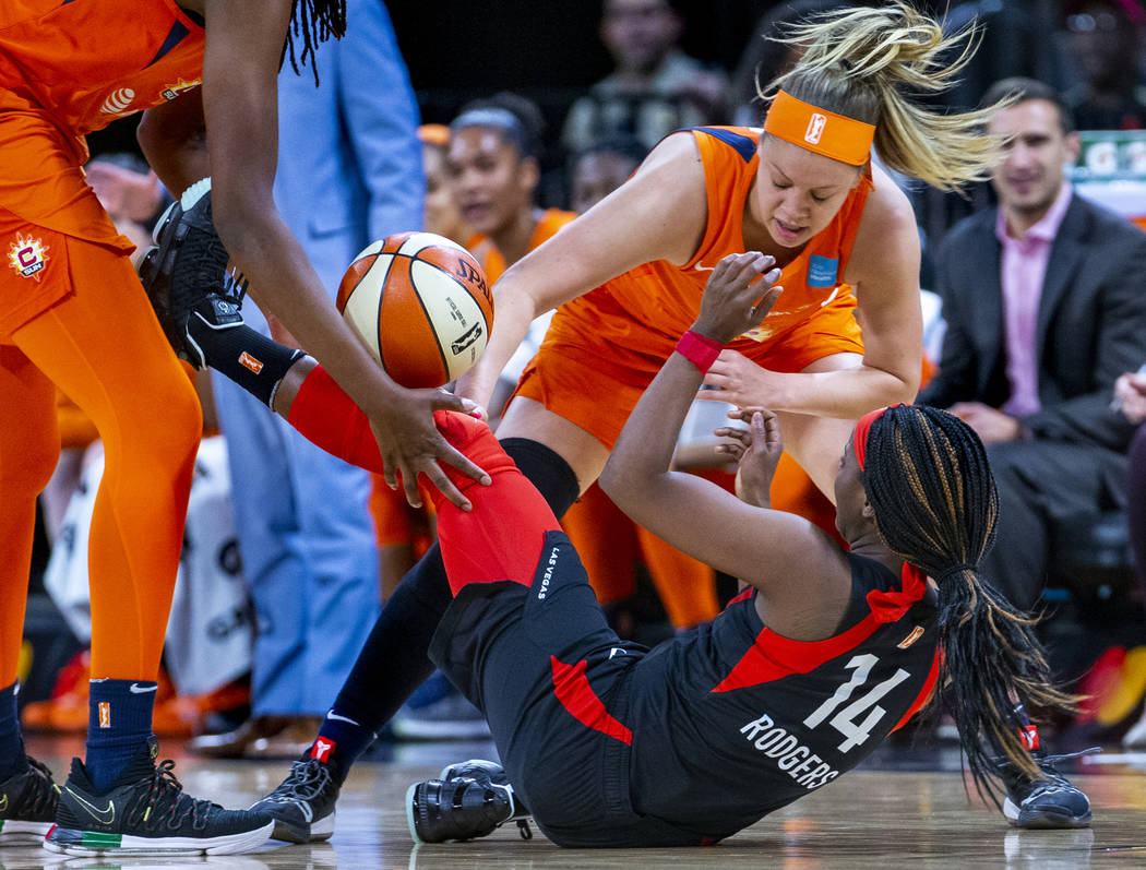 Connecticut Sun guard Rachel Banham (1) bats the ball away from Las Vegas Aces guard Sugar Rodg ...