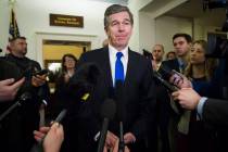 FILE - In a Feb. 6, 2019 file photo, North Carolina Gov. Roy Cooper speaks with reporters after ...