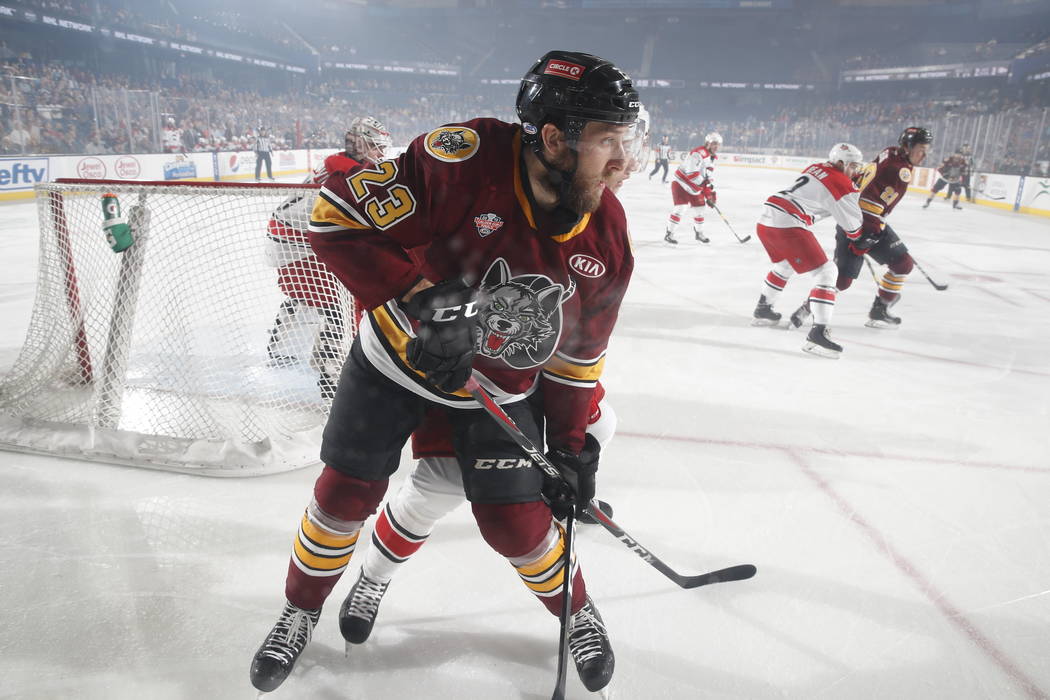 Chicago Wolves center Stefan Matteau (23) battles a Charlotte Checkers skater in the first peri ...