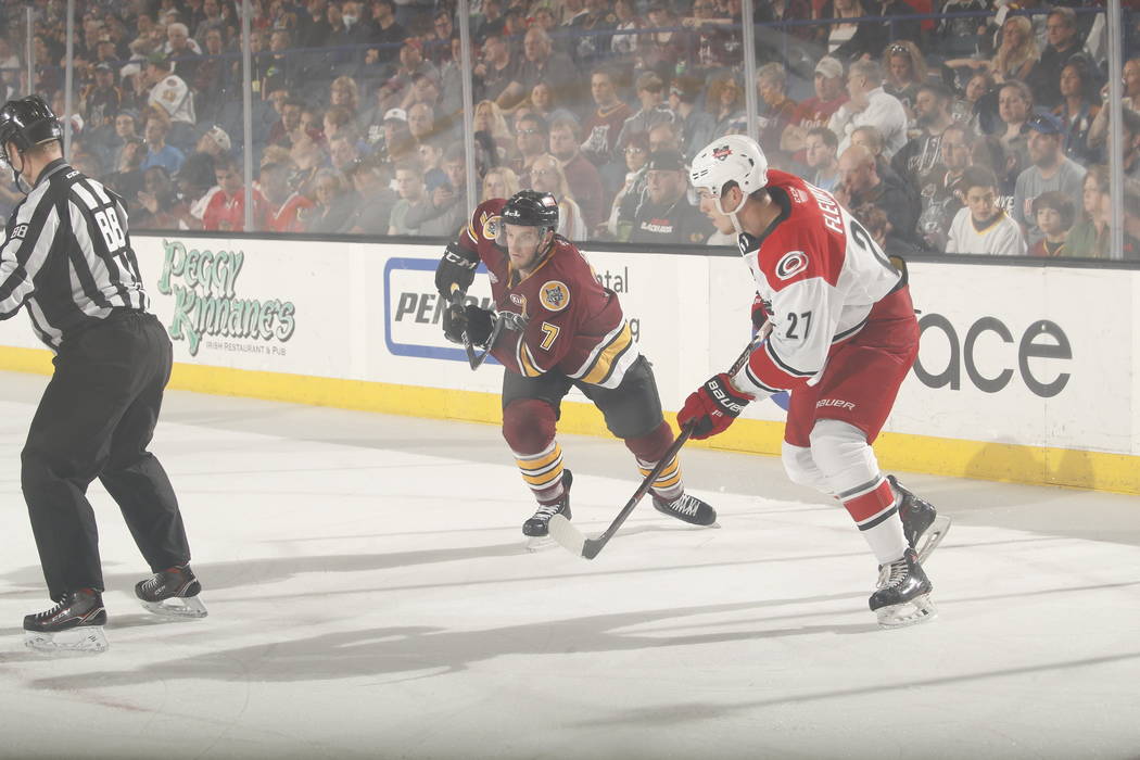 Chicago Wolves left wing Daniel Carr (7) and Charlotte Checkers defenseman Haydn Fleury (27) sk ...