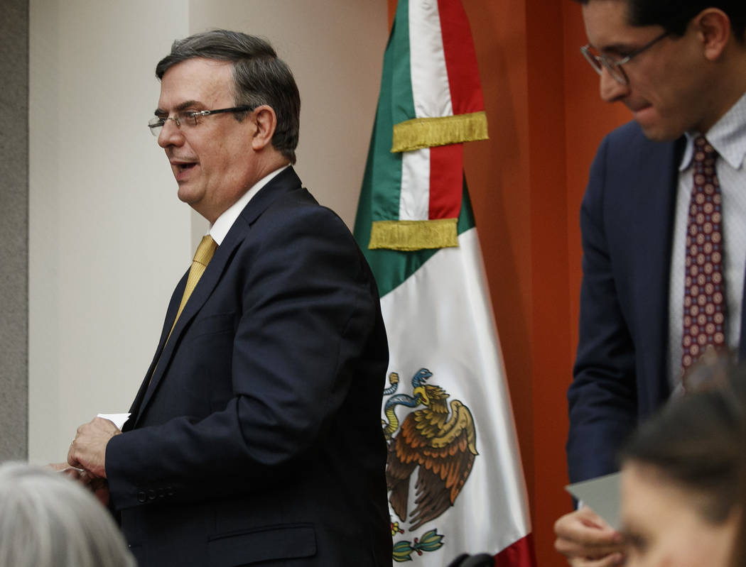 Marcelo Ebrard, Mexico's Secretary of Foreign Affairs, walks past the Mexican flag as he leaves ...