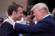 French President Emmanuel Macron, left, meets U.S President Donald Trump during a ceremony to m ...
