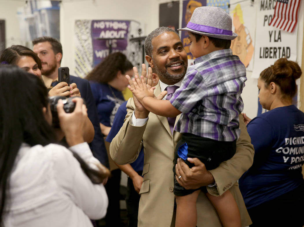 Rep. Steven Horsford, D-Nev., greets Noah Silva, 3, before a news conference in Las Vegas Frida ...