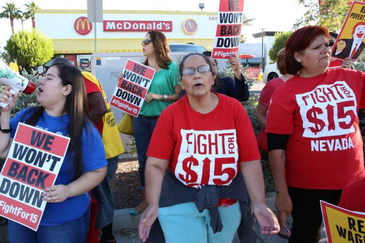 McDonald's franchise employees, including Diana Diaz, center, and Lupe Guzman, right, protest f ...