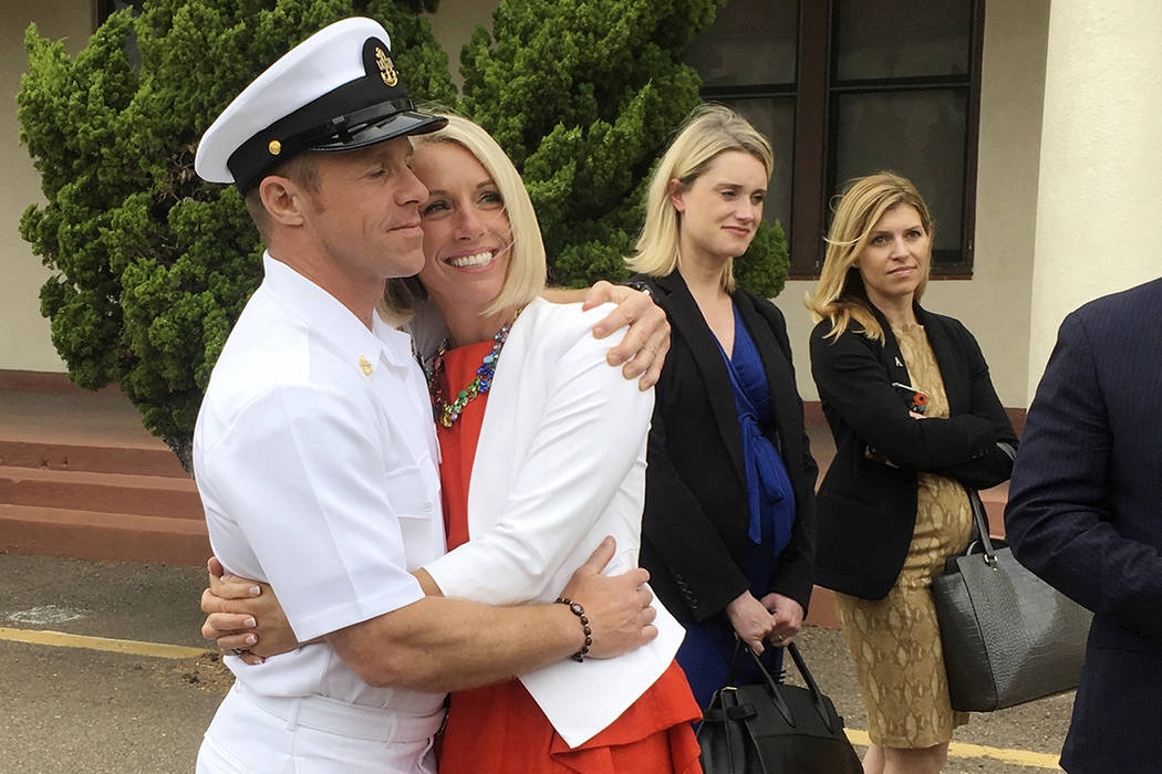 Navy Special Operations Chief Edward Gallagher, left, hugs his wife, Andrea Gallagher, after le ...