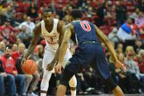 UNLV Rebels guard Amauri Hardy (3) starts a play while being guarded by Fresno State Bulldogs g ...
