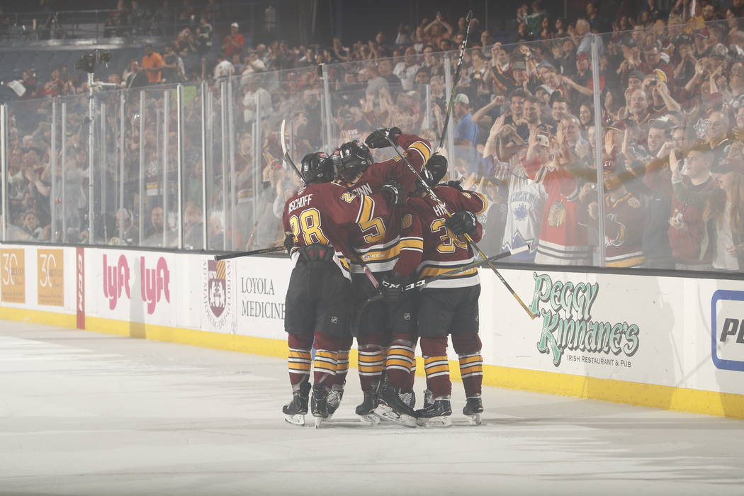 The Chicago Wolves celebrate a goal against the Charlotte Checker in the first period of Game 4 ...
