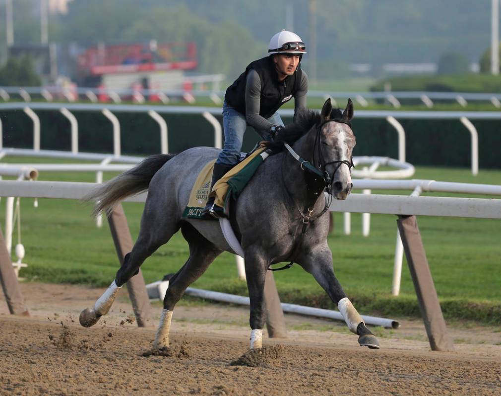 Exercise rider Joe Ramos rides Tacitus during a workout at Belmont Park in Elmont, N.Y., Thursd ...