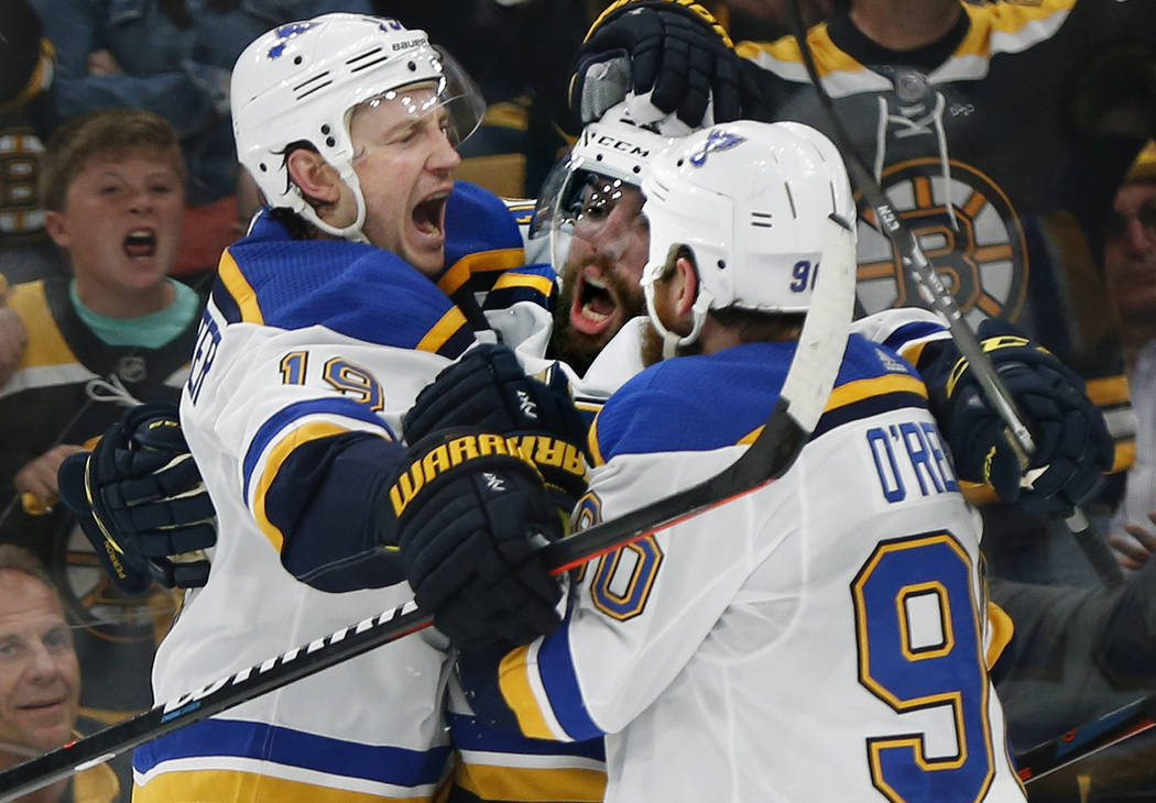 St. Louis Blues' David Perron, center, celebrates his goal against the Boston Bruins with Jay B ...