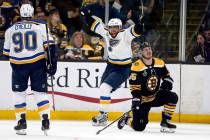 St. Louis Blues' David Perron, center, celebrates his goal behind Boston Bruins' Noel Acciari, ...