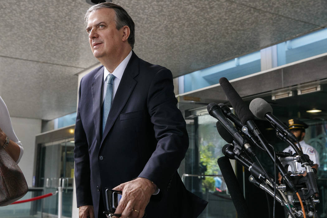 Marcelo Ebrard, Mexico's Secretary of Foreign Affairs, leans in to hear a question from the med ...