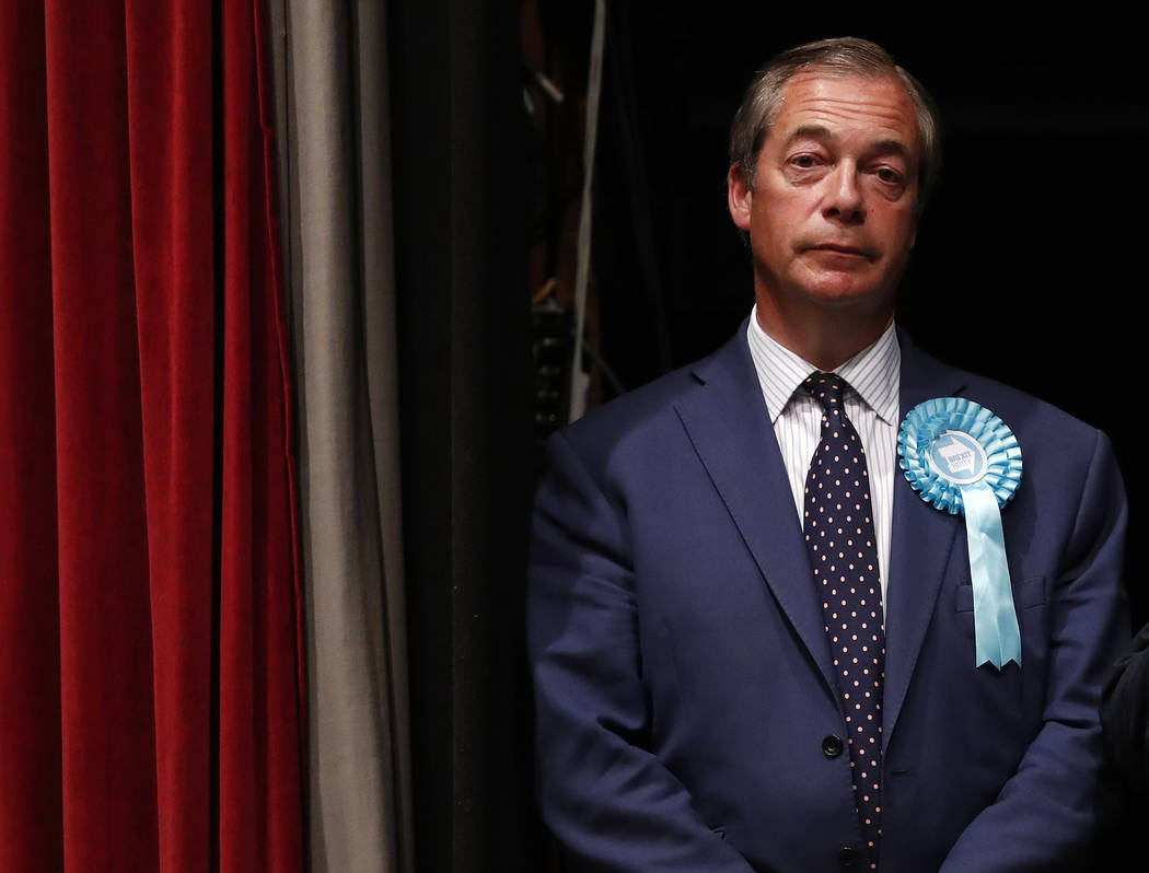 Brexit Party leader Nigel Farage stands on the stage as results are announced at the counting c ...