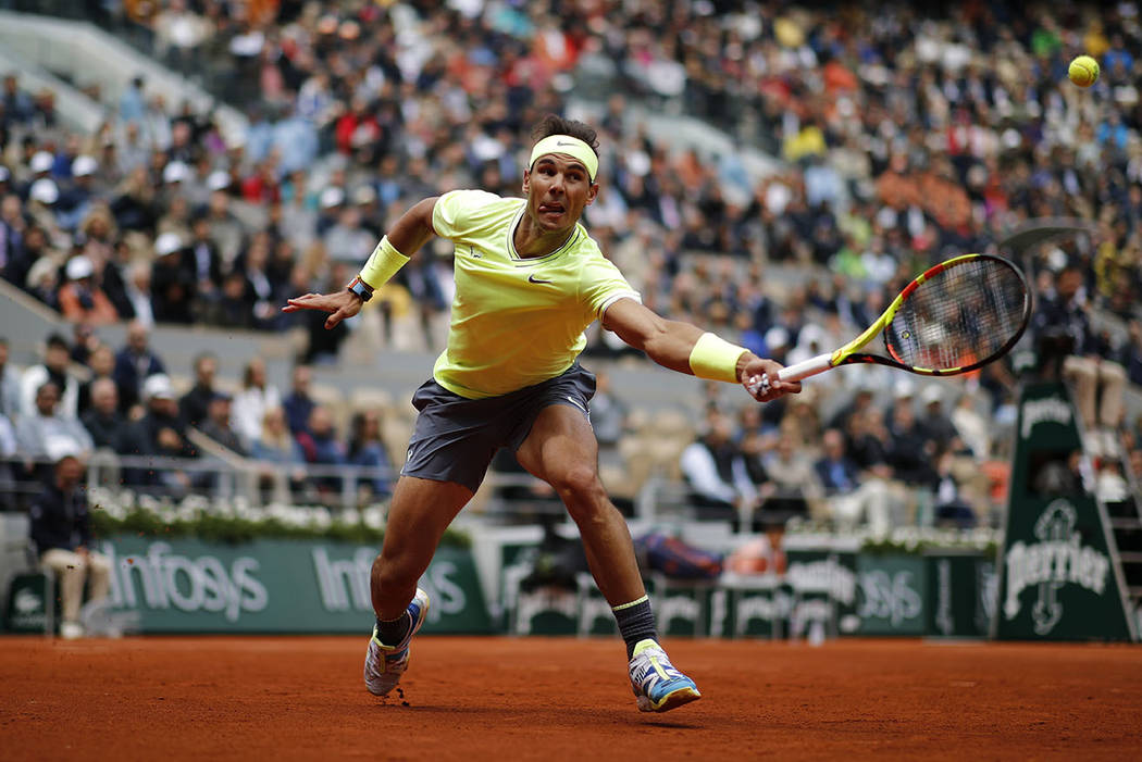 Spain's Rafael Nadal plays a shot against Switzerland's Roger Federer during their semifinal ma ...