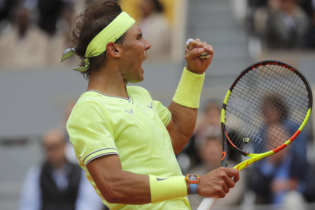 Spain's Rafael Nadal clenches his fist after scoring a point against Switzerland's Roger Federe ...