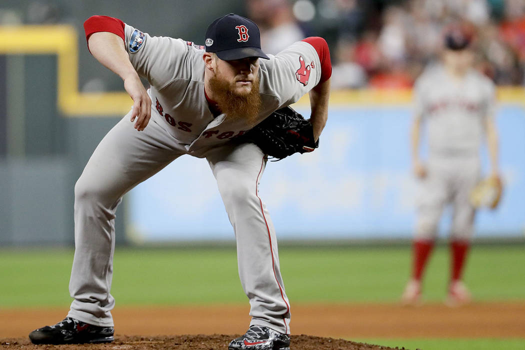 In this Oct. 17, 2018, file photo, Boston Red Sox relief pitcher Craig Kimbrel prepares to thr ...