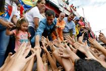 Venezuela's opposition leader and self-proclaimed interim president Juan Guaido greets supporte ...