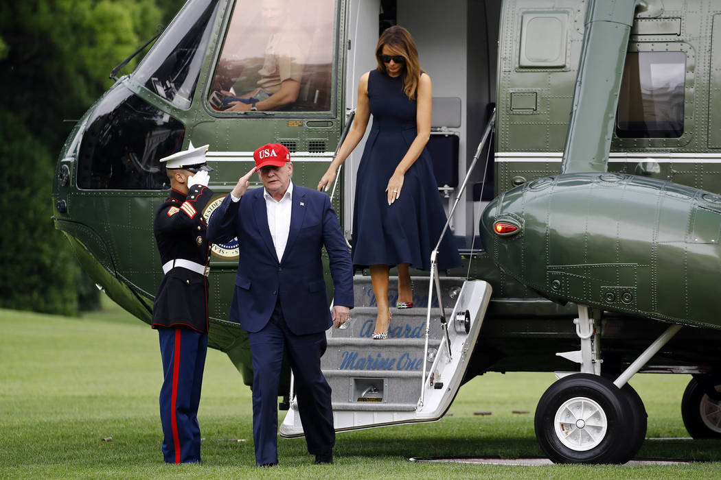 President Donald Trump and first lady Melania Trump step off Marine One on the South Lawn of th ...