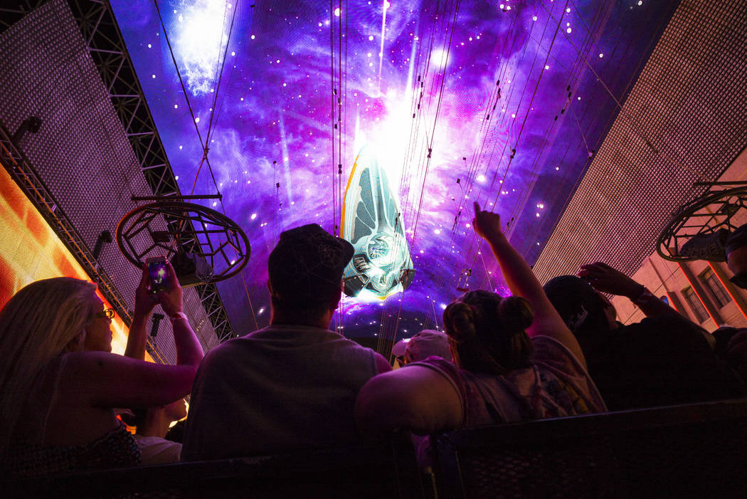 Fans watch the Steve Aoki Viva Vision light show at the Fremont Street Experience in downtown L ...