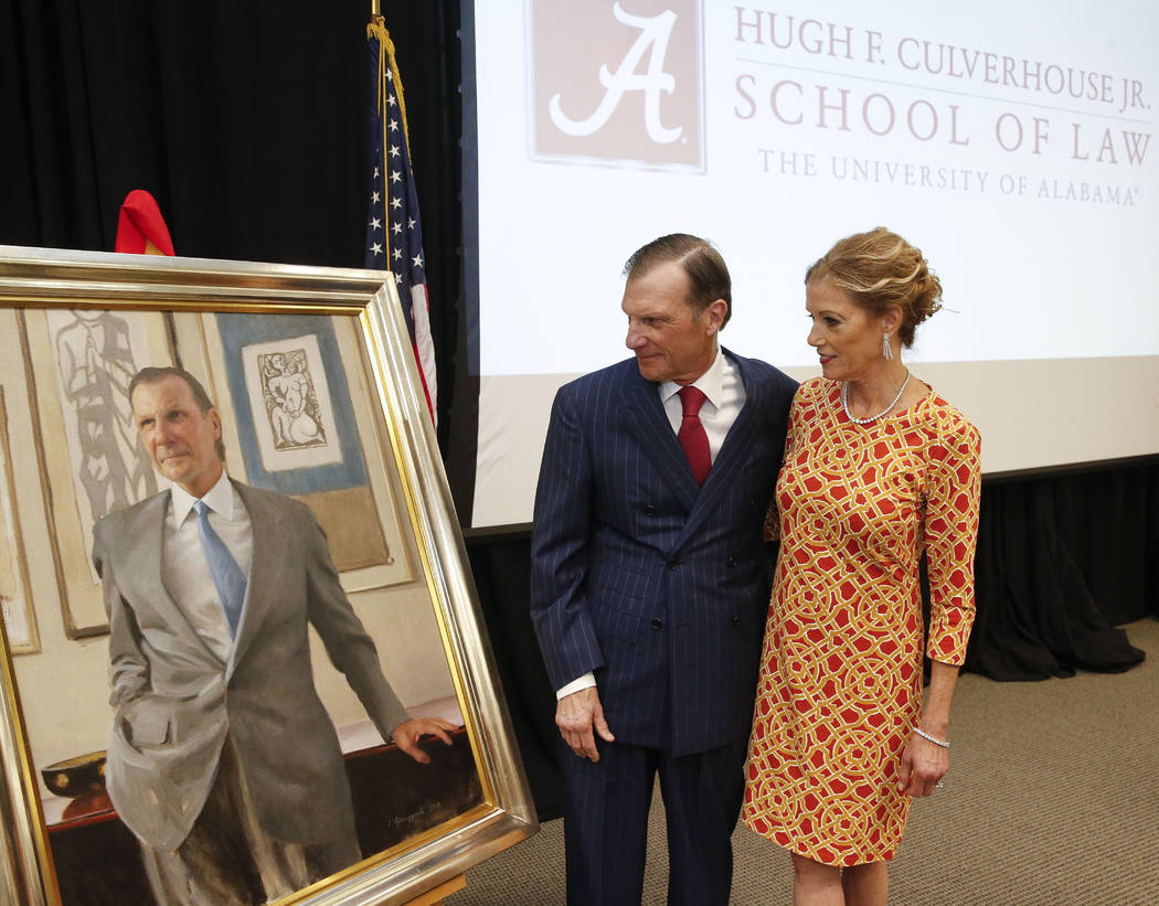 In this Sept. 20, 2018, photo, Hugh F. Culverhouse Jr. and his wife, Eliza, look at a portrait ...