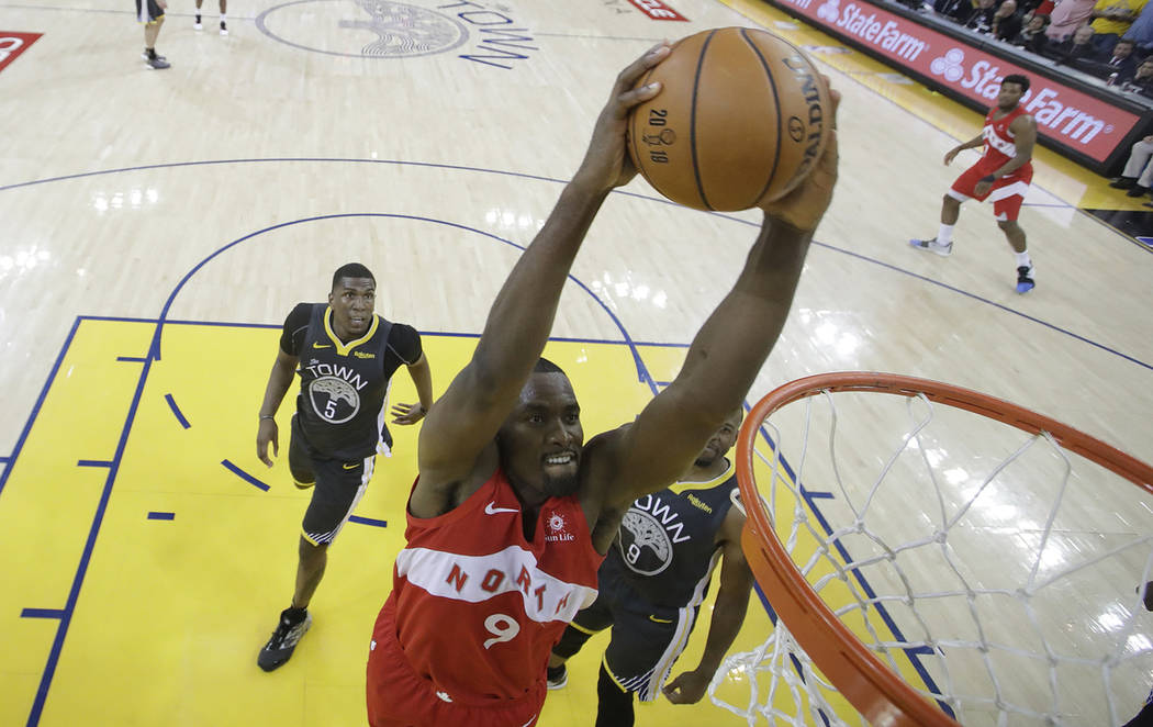 Toronto Raptors center Serge Ibaka (9) dunks against the Golden State Warriors during the secon ...
