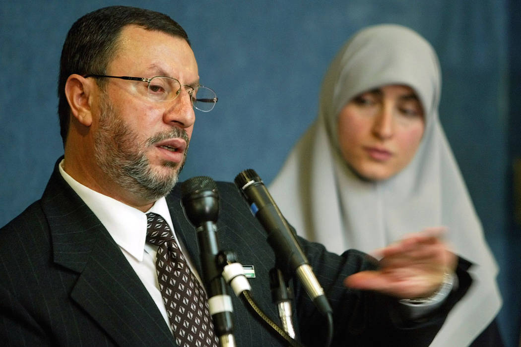 In this Feb. 16, 2004 file photo, Abdelhaleem Ashqar, left, with his wife Asma, right, meets r ...