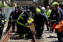 This photo provided by the Boston Fire Department, Firefighters and EMT personnel carry an inju ...