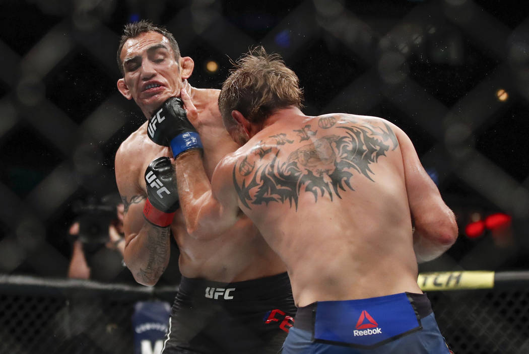 Donald Cerrone, right, lands a punch against Tony Ferguson during their lightweight mixed marti ...