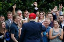 President Donald Trump greets supporters on his return to the White House, Friday June 7, 2019, ...
