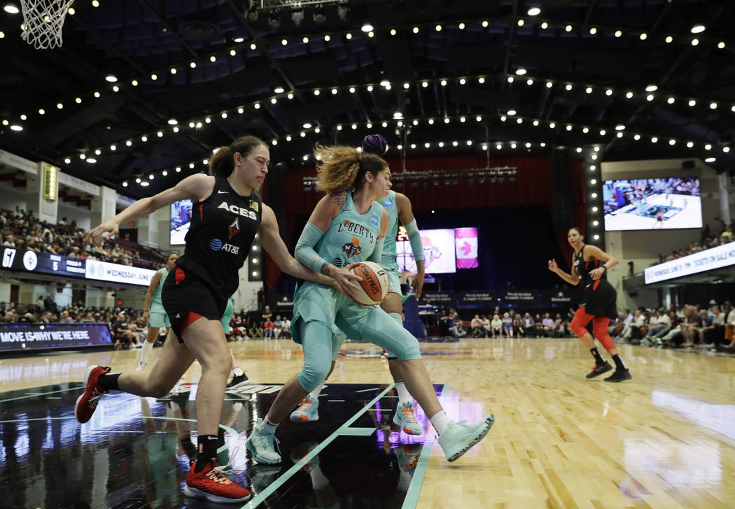 New York Liberty's Amanda Zahui B, center, of Sweden, pulls down a defensive rebound against th ...