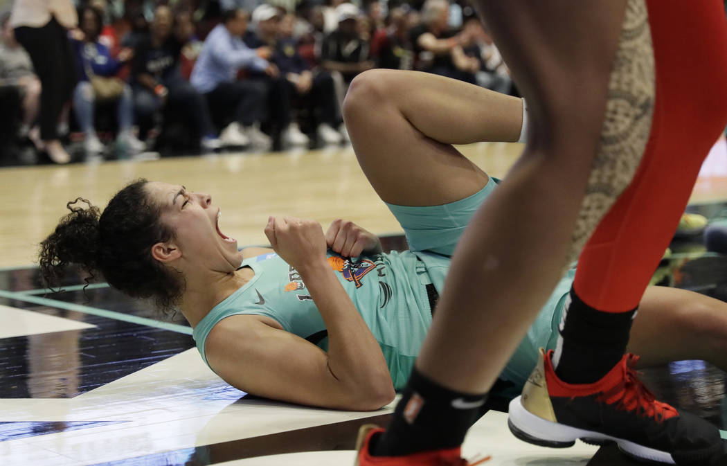 New York Liberty's Kia Nurse falls to the court after drawing an offensive foul against Las Veg ...