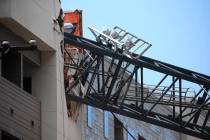 Officials respond to the scene after a crane collapsed into Elan City Lights apartments amid se ...