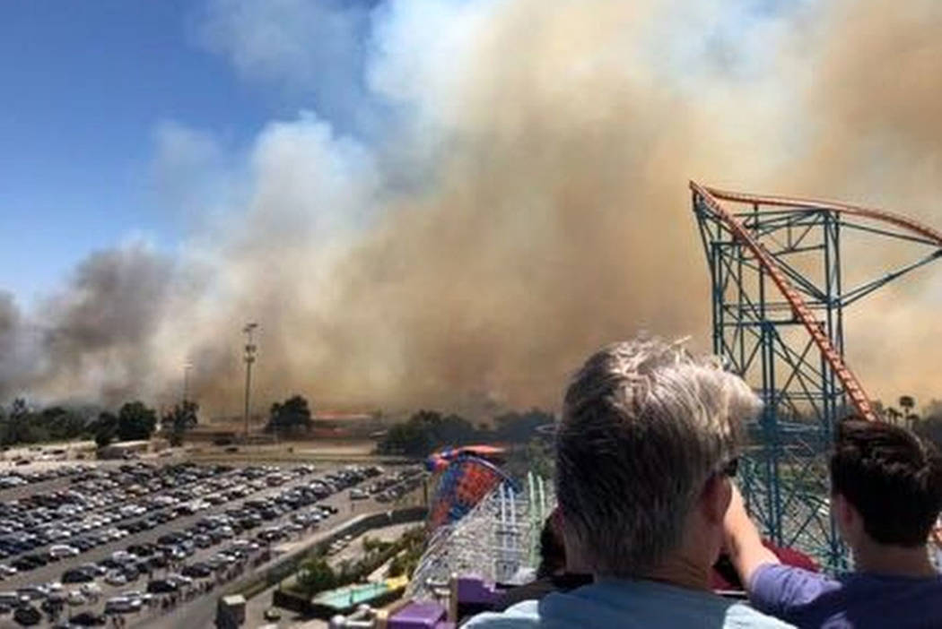 Smoke from a fast-moving brush fire is seen at Six Flags in Valencia, north of Los Angeles. (Ry ...