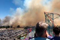 Smoke from a fast-moving brush fire is seen at Six Flags in Valencia, north of Los Angeles. (Ry ...