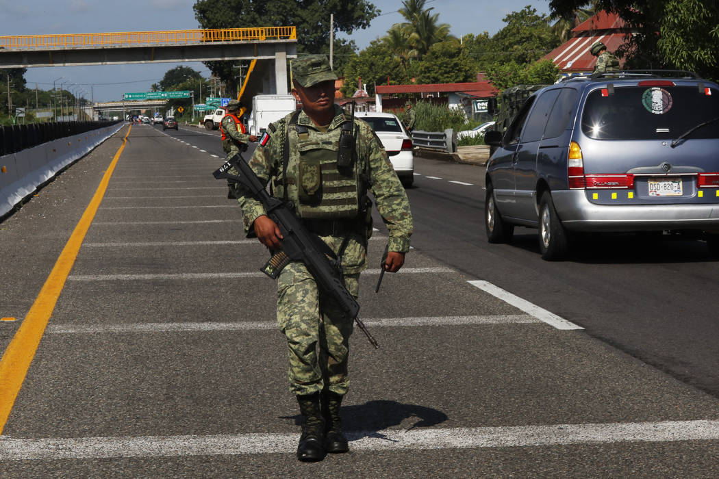 A Mexican Army soldier walks on the highway, near an immigration checkpoint in Tapachula, Chiap ...