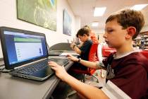 Third-grade student Miles Stidham uses an East Webster High School laptop to do homework in Mab ...