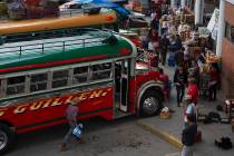 In this June 8, 2019, photo, people wait for a bus at the terminal in San Marcos, Guatemala. Th ...