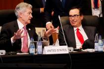 Federal Reserve Chairman Jerome Powell talks with U.S. Treasury Secretary Steven Mnuchin during ...
