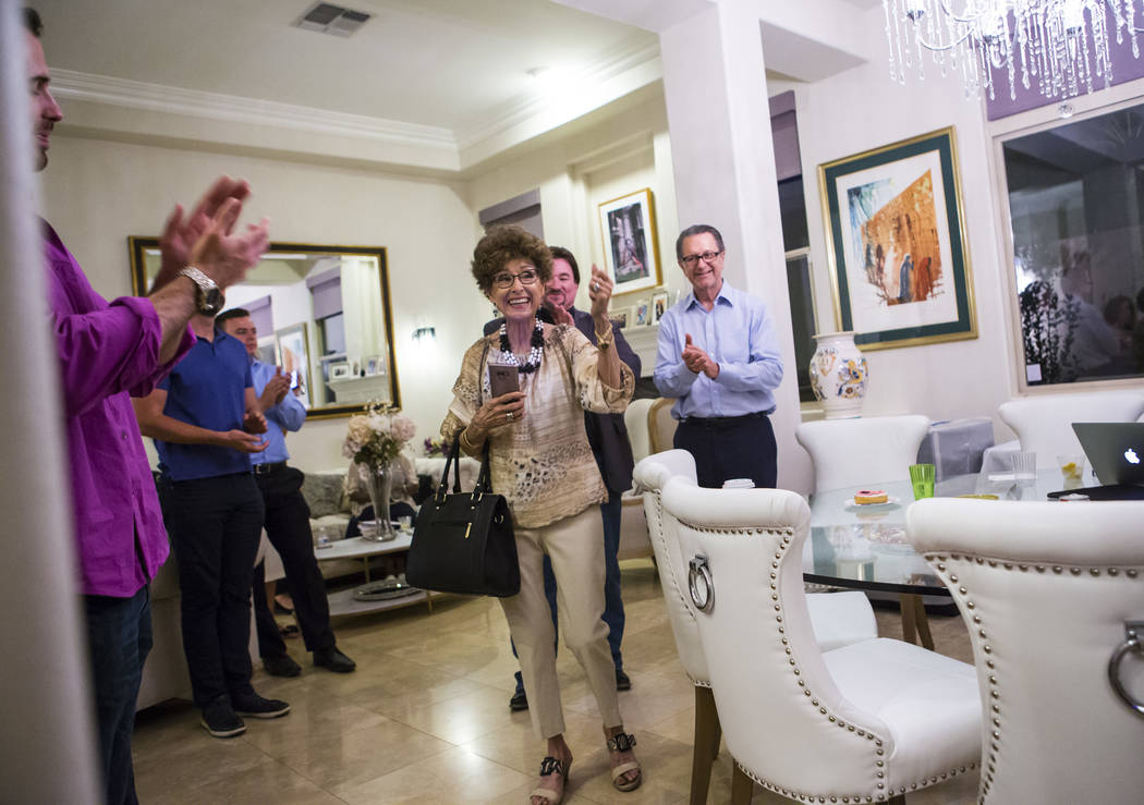 Evelyn Cannestra, center, celebrates as voting results are updated, projecting Las Vegas City C ...