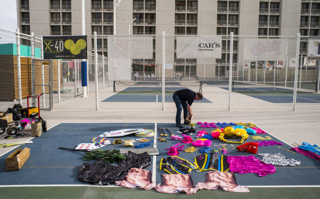 Brett Lashbrook, owner and CEO of Lights FC, right, looks through props while setting up for th ...