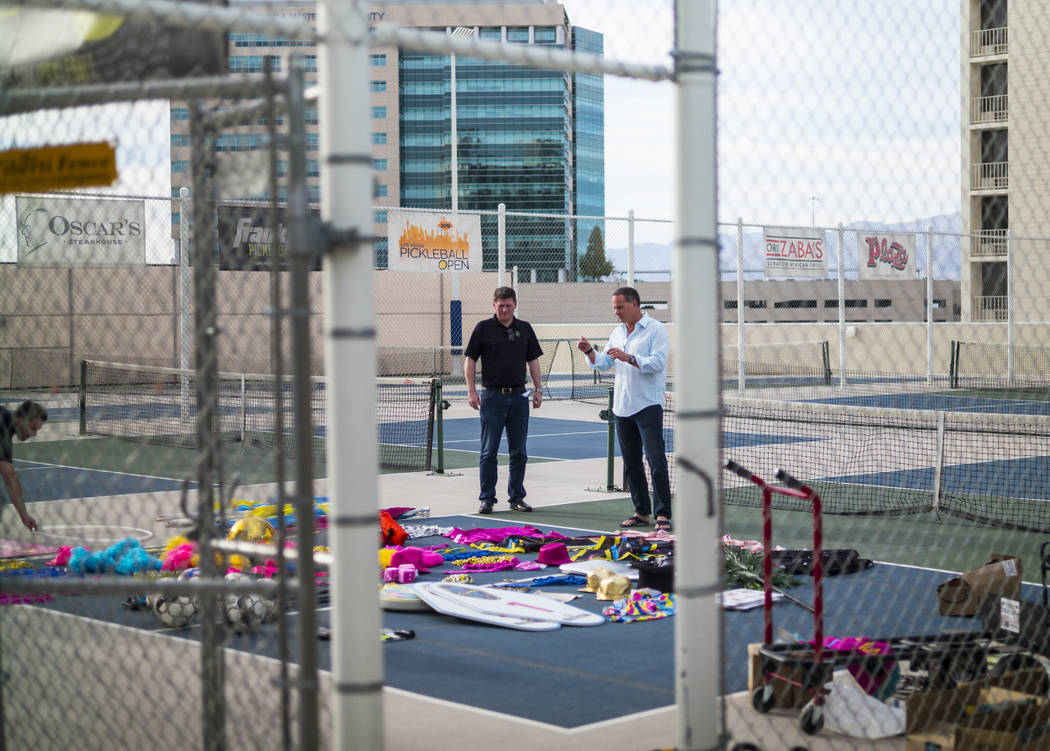 Brett Lashbrook, owner and CEO of Lights FC, left, looks through props with Lights FC head coac ...