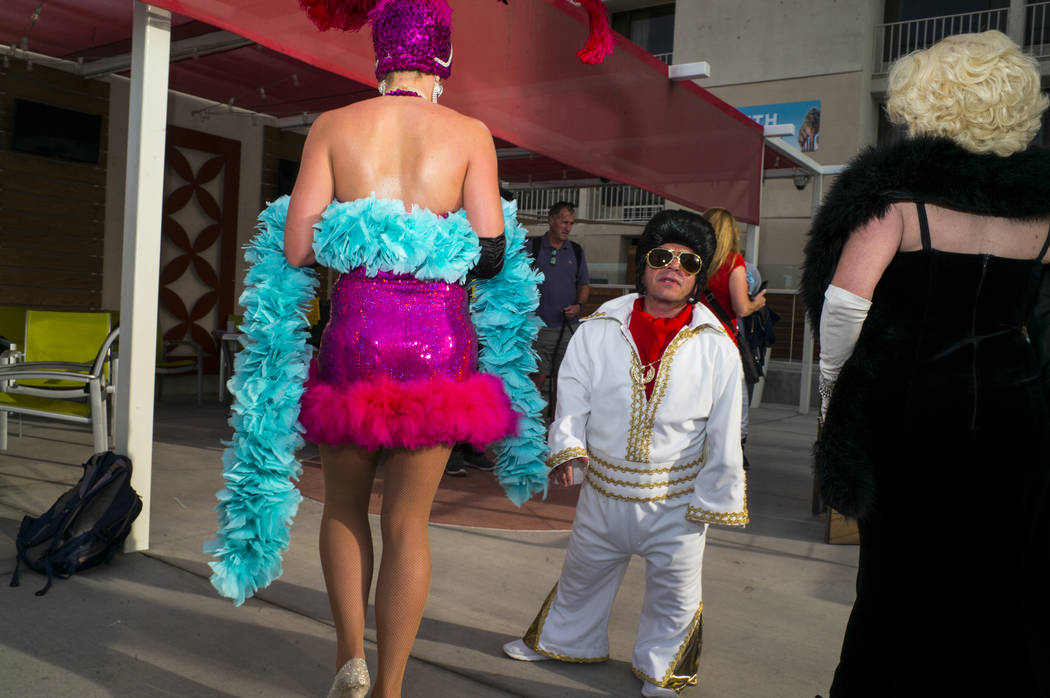 Dimos Greko, who also goes by "Mini Elvis," looks on before joining in on a team phot ...