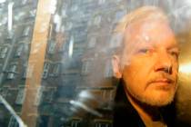 In a Wednesday, May 1, 2019, file photo, buildings are reflected in the window as WikiLeaks fou ...