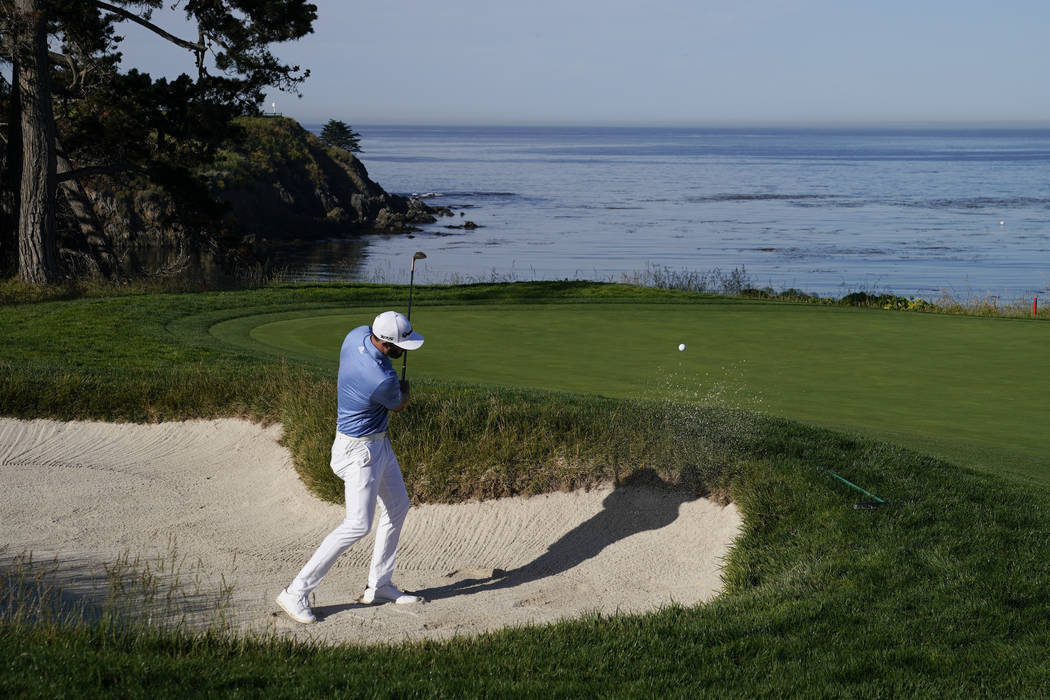 Dustin Johnson hits out of the bunker on the fifth hole during a practice round for the U.S. Op ...