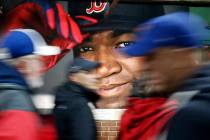 In this Oct. 1, 2016, file photo, fans at walk past a photograph of Boston Red Sox's David Orti ...