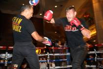 Tom Schwarz, right, throws a punch during an open workout event at the MGM Grand hotel-casino i ...