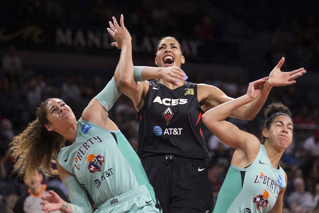 Las Vegas Aces center Liz Cambage (8) fights for position with New York Liberty center Amanda Z ...